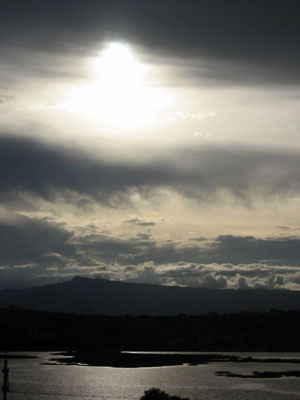 Cochabamba, la laguna alalay, ses collines et une lumiere diffuse traversant les nuages